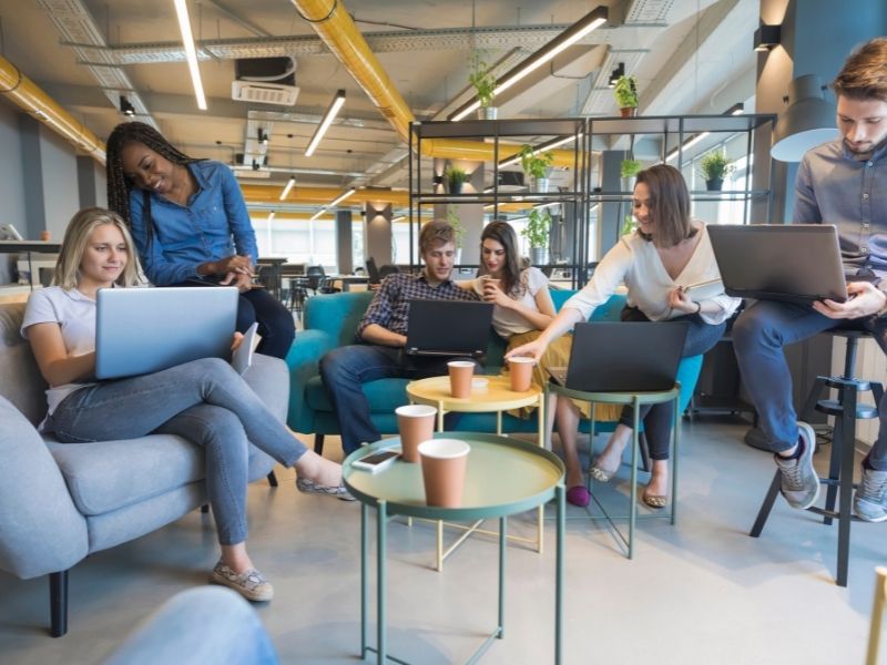 A group of young people in a coworking space common area