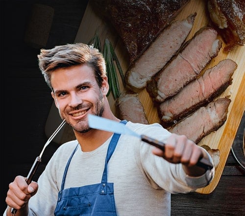 A photo of a man holding grilling tools