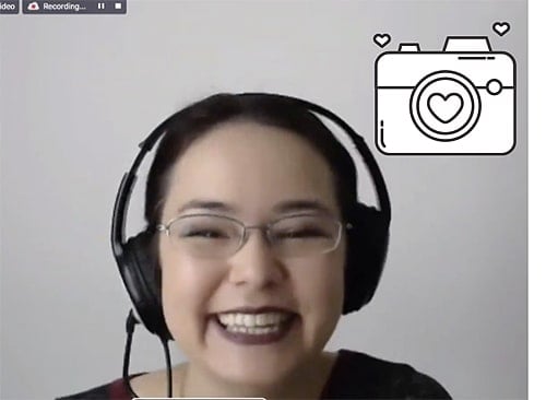 A photo of a smiling woman on a video call